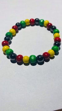 a bracelet with red, green, and yellow beads