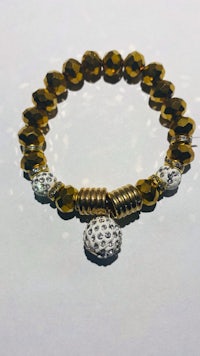 a bracelet with a gold and silver charm