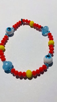 a bracelet with red, blue and yellow beads