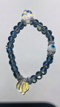 a bracelet with an evil eye on it