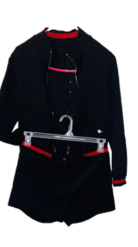 a black jacket hanging on a hanger