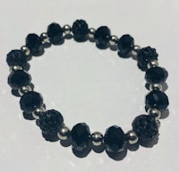 a black stretch bracelet with silver beads