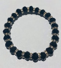 a black stretch bracelet with silver beading