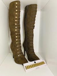 a pair of green suede boots with gold studs